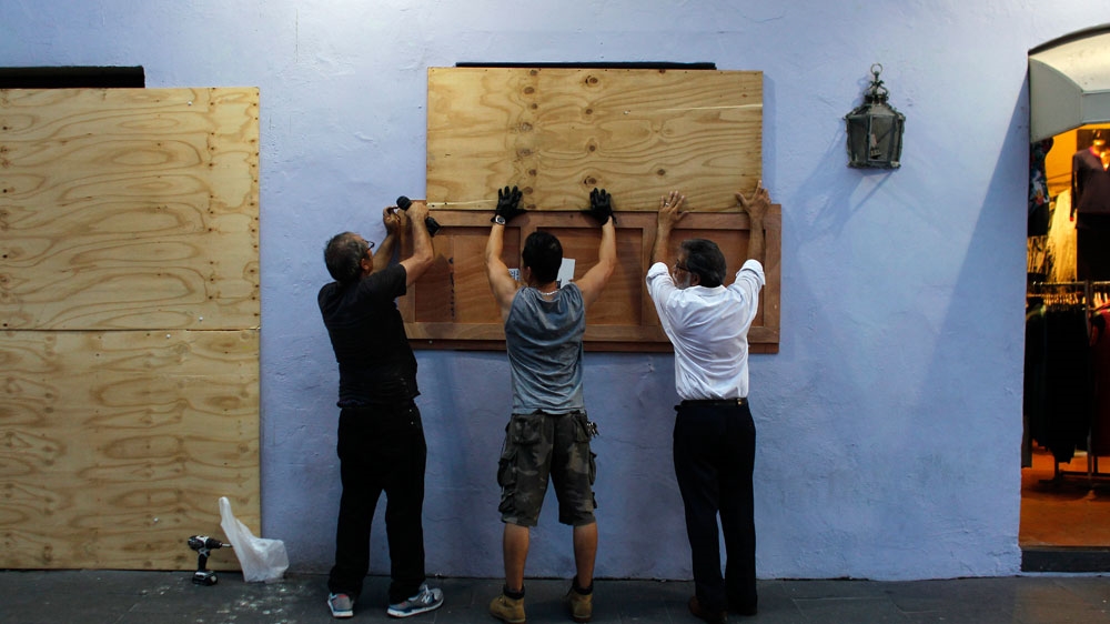 People board up windows of a business in preparation for the anticipated arrival of Hurricane Maria in San Juan, Puerto Rico [Ricardo Arduengo/AFP]