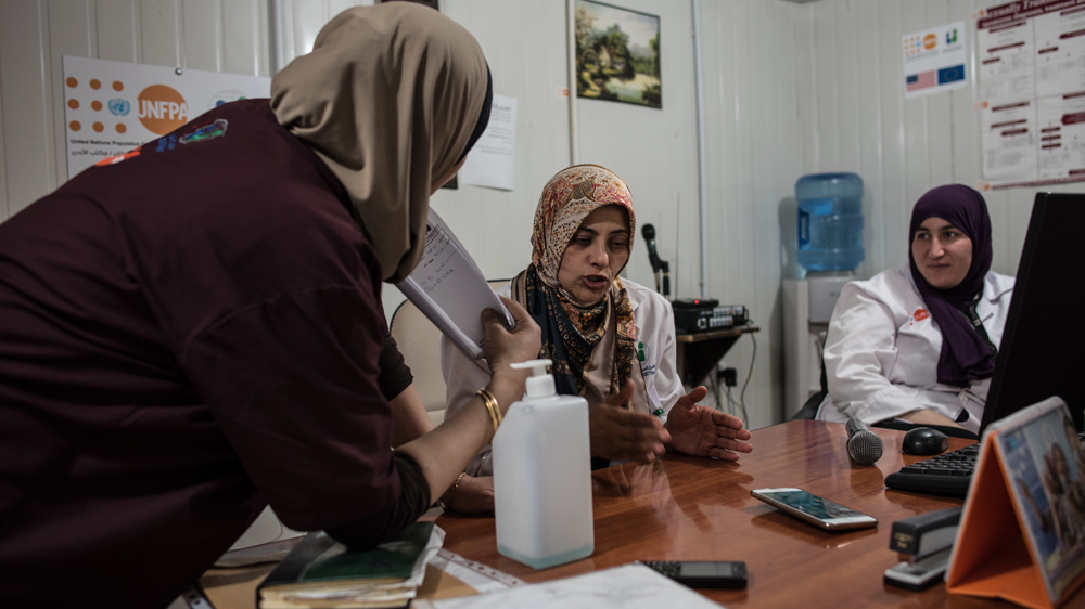 Dr Diab discusses a patient's case with her staff [Hannah Long-Higgins/Al Jazeera]