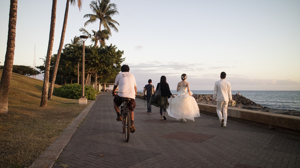 Junior rides his bike to the harbour to collect bottles from a tourist boat [Emre Caylak/Al Jazeera]