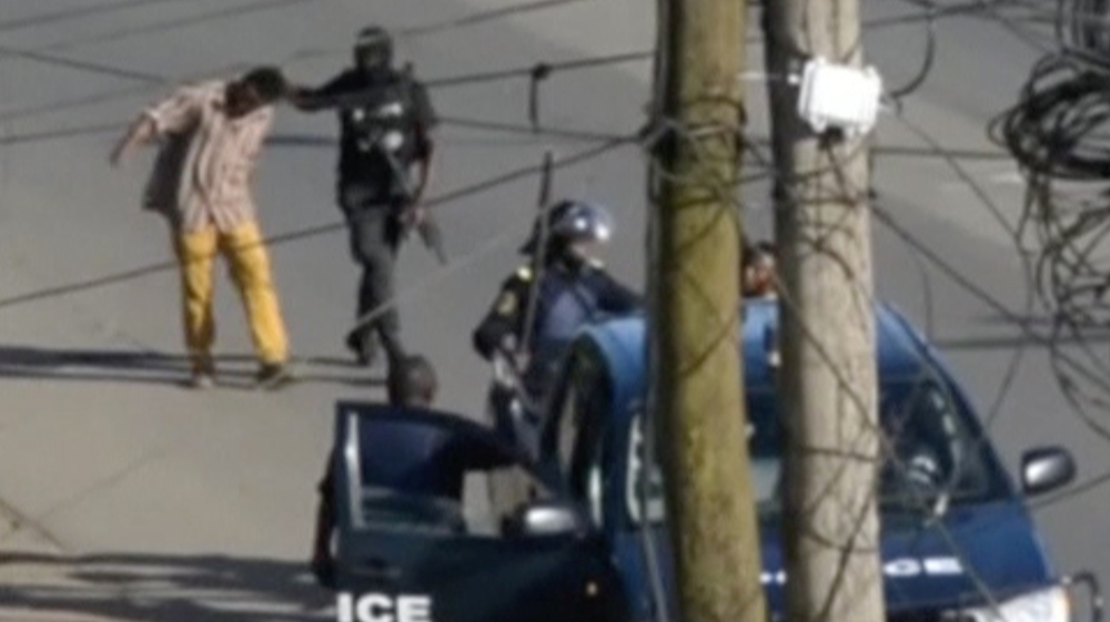 A still image taken from a video shows police arresting a man in the English-speaking city of Buea