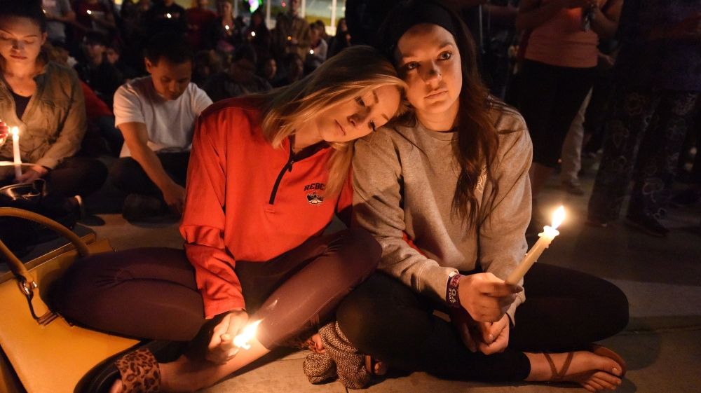 
People attend a candlelight vigil at the University of Las Vegas student union [Robyn Beck/AFP/Getty Images] A candlelight vigil was held on the Las Vegas strip following the mass shooting [Chris Wattie/Reuters] A candlelight vigil was held on the Las Vegas strip following the mass shooting [Chris Wattie/Reuters] 
