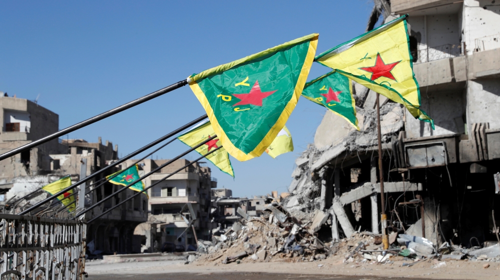 Syrian Democratic Forces flags are pictured at Naim Roundabout in Raqqa