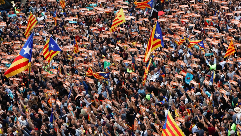 People wave Esteladas (Catalan separatist flags) during celebrations in Sant Jaume square after the Catalan regional parliament declared independence from Spain in Barcelona