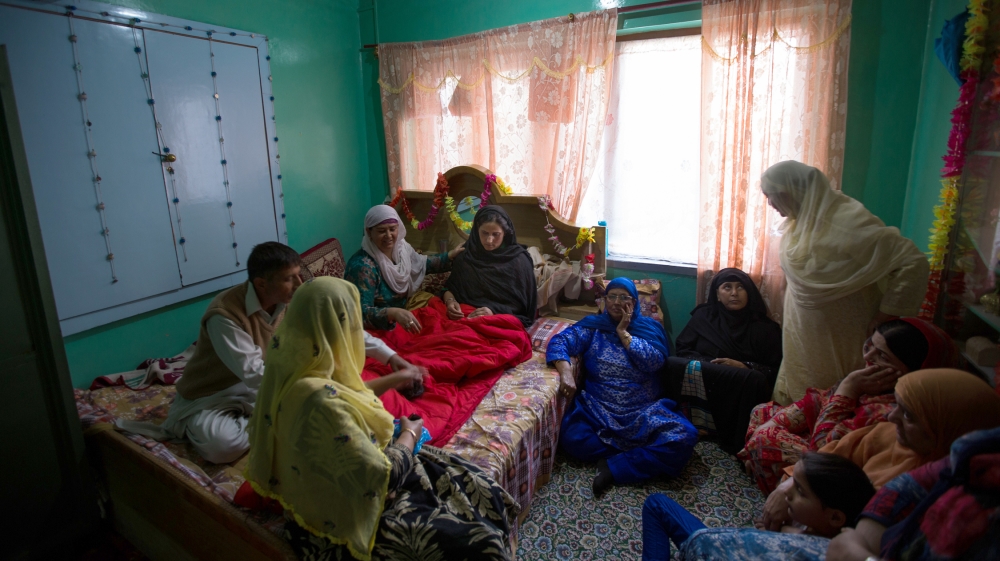 - Gulshan, in shock, is being consoled by the neighbors at her house in Batamalo area of Srinagar, India-administered Kashmir.
