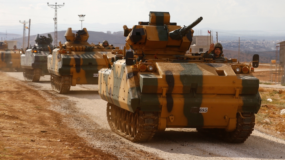 Turkish military convoy drives by village on Turkish-Syrian border line in Reyhanli
