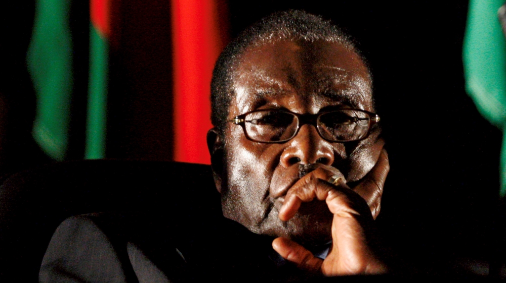 FILE PHOTO - File photo of Zimbabwean President Robert Mugabe watching a video presentation during SADC in Johannesburg