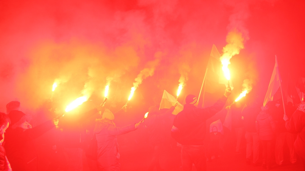 The sky bled as people set off flares [Agnieszka Pikulicka-Wilczewska/Al Jazeera]