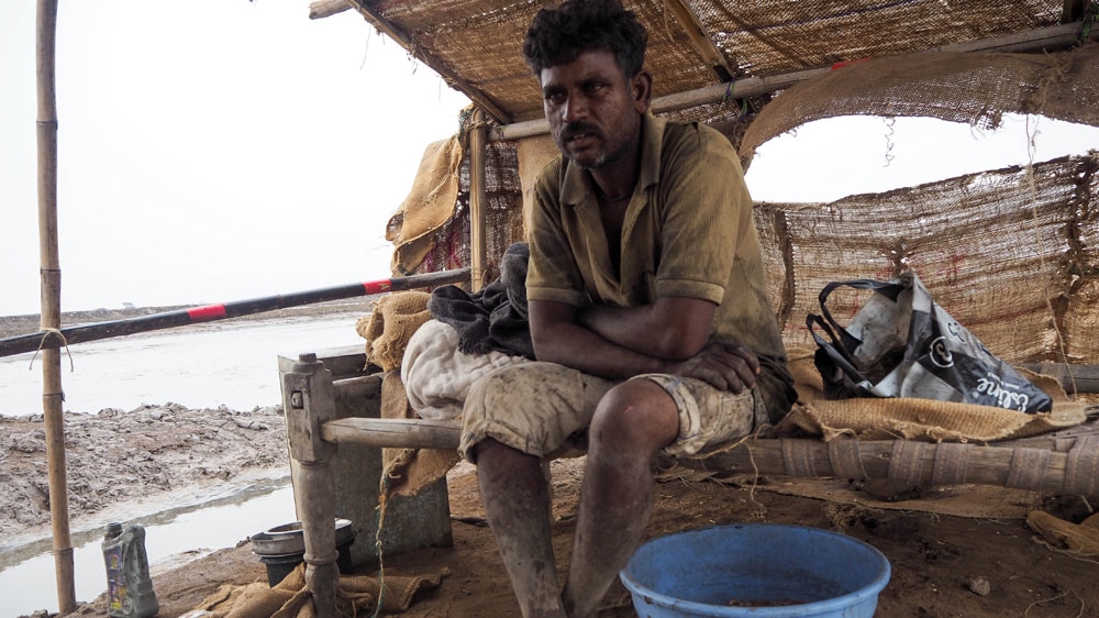Raju, an Agariya who lives alone in the Morbi district, is pictured in his hut [Sharanya Deepak/Al Jazeera] 
