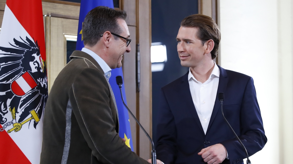 Head of the FPOe Strache and head of the OeVP Kurz shake hands at the end of a news conference in Vienna