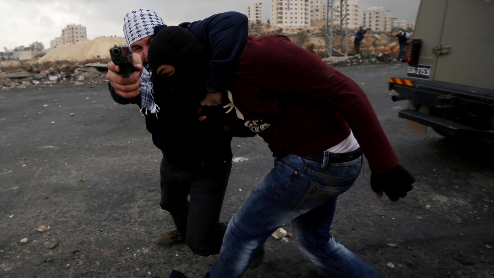 Undercover Israeli security personnel detain a Palestinian demonstrator during clashes at a protest near the Jewish settlement of Beit El, near the West Bank city of Ramallah
