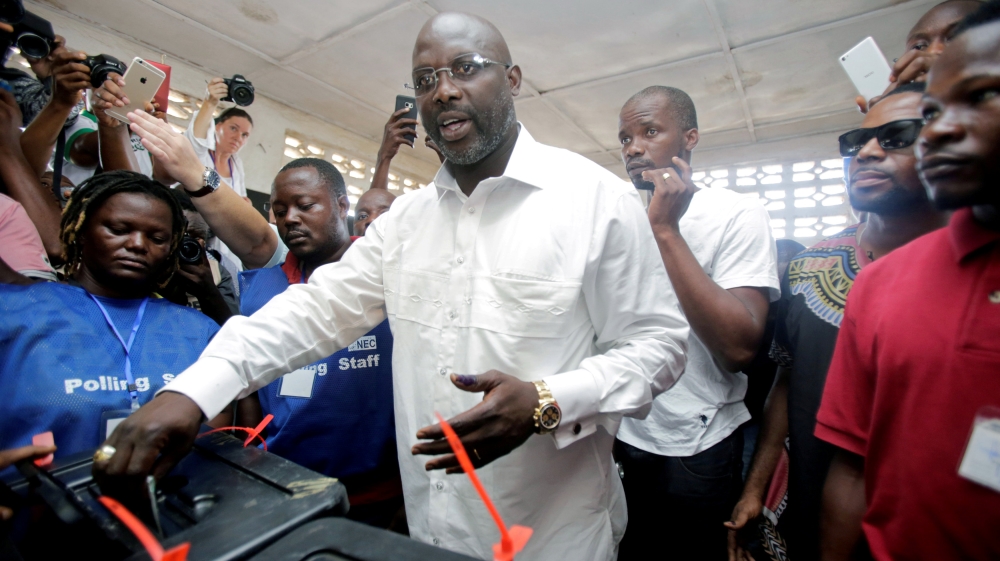 George Weah, former soccer player and presidential candidate of Congress for Democratic Change (CDC), votes at a polling station in Monrovia, Liberia, October 10, 2017