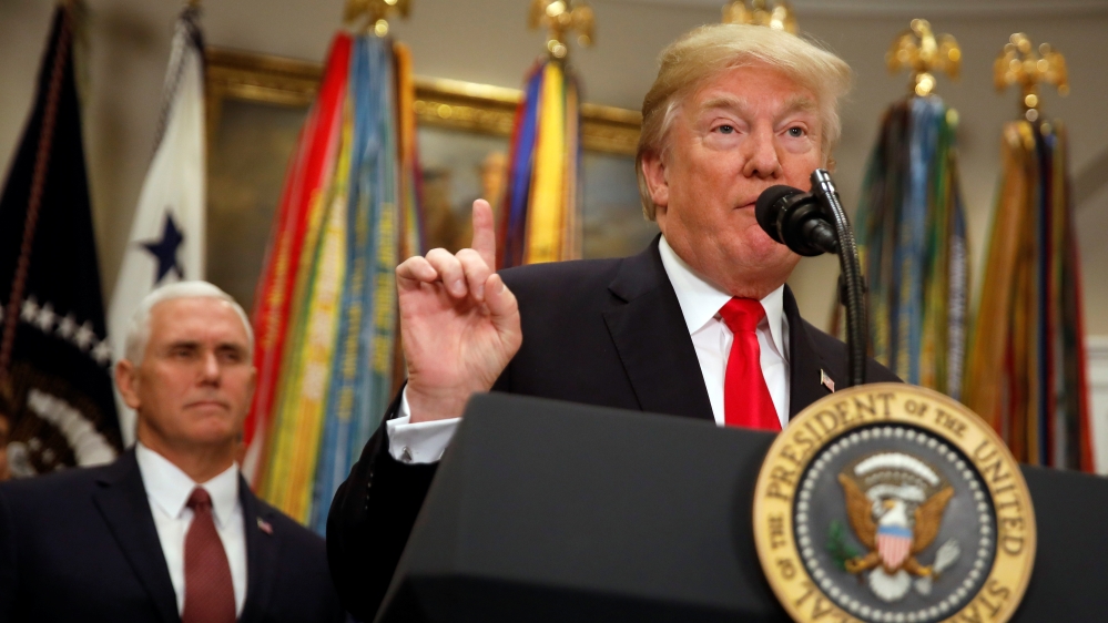 President Donald Trump signs the National Defense Authorization Act for Fiscal Year 2018, accompanied by Vice President Mike Pence, at the White House in Washington D.C.
