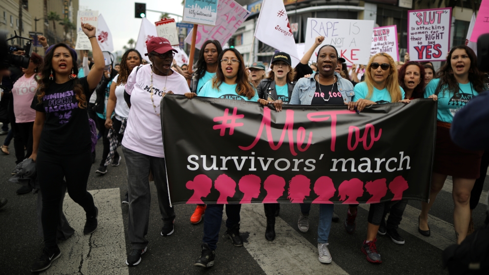 People participate in a protest march for survivors of sexual assault and their supporters in Hollywood
