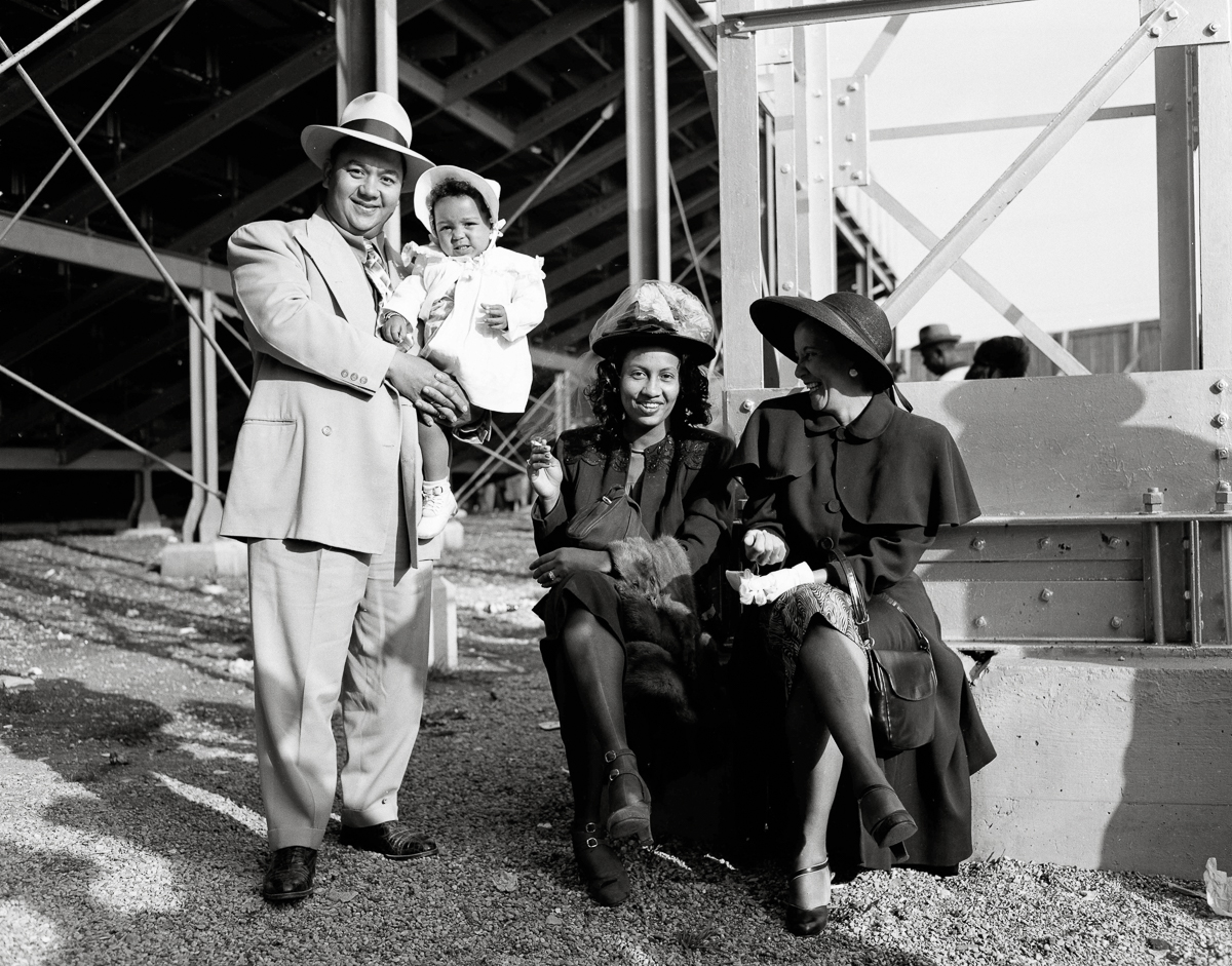 6: Attendees at the Jackie Robinson All-Star exhibition baseball game posing for Littlejohn under the stadium steps on 11 November 1949 (Robinson was the first African American to play in Major League
