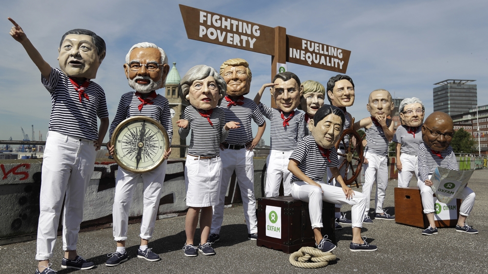 
A report published by Oxfam ahead of the summit revealed that billionaires increased their wealth by $762bn last year, enough to end 'global extreme poverty seven times over' [Matthias Schrader/AP]
