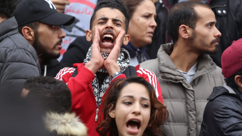 Demonstrating graduate shouts slogans during protests against rising prices and tax increases, in Tunis
