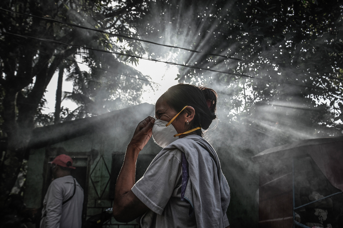 A woman fixes her face mask amidst heavy ashfall from Mount Mayon''s eruption in Guinobatan, Albay province, Philippines, January 23, 2018. Residents were reminded to exercise causion has heavy ashfall