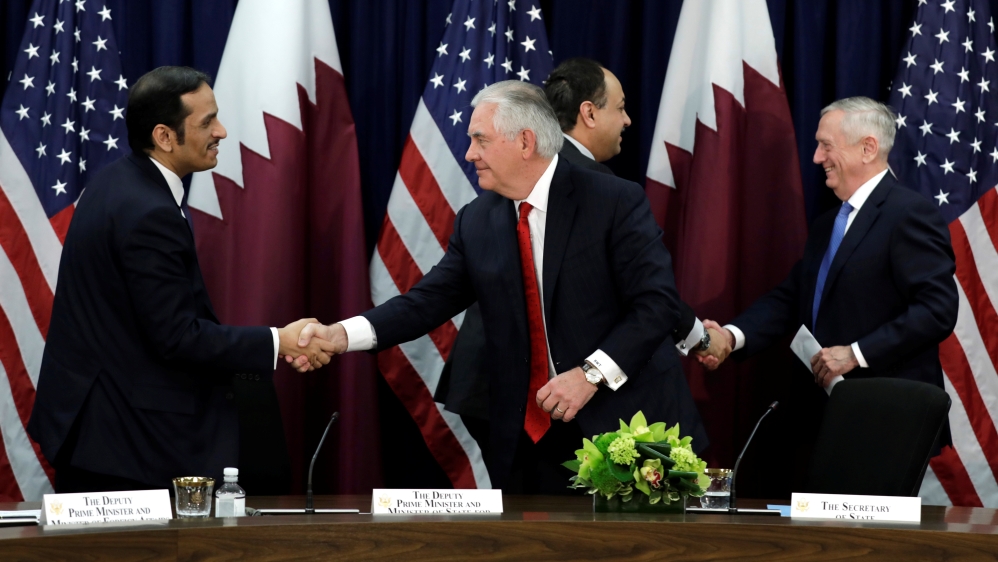 Rex Tillerson and Defense Secretary Jim Mattis shake hands with Qatari Foreign Minister Sheikh Mohammed bin Abdulrahman Al Thani and Defense Minister Khalid bin Muhammad al-Attiyah