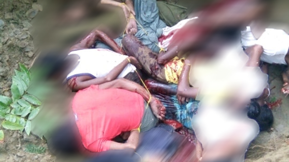 The bodies of 10 Rohingya Muslim men lie in a shallow grave in Inn Din village, Myanmar, in this undated image obtained by Reuters on November 22 [Reuters]