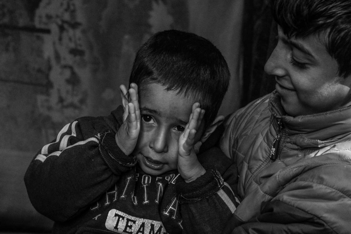 Five-year ld Ahil covers his face to avoid being photographed at his house at village Sangam , 38 km south of Srinagar city. Ahil''s father, an Indian army trooper was killed in a militant ambush last