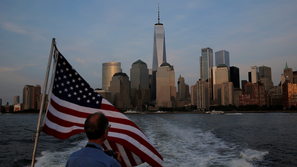 A man looks back toward lower Manhattan and One World Trade Center while riding the Liberty Landing Ferry across the Hudson River on the 16th anniversary of the September 11 attacks in New York, U.S.