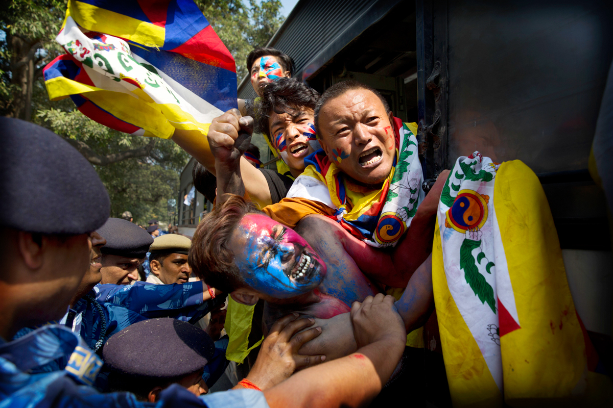 Indian para-military force soldiers push exile Tibetan activists into a police bus during a protest outside the Chinese Embassy, in New Delhi, India, Friday, March 9, 2018. The protest was to mark the