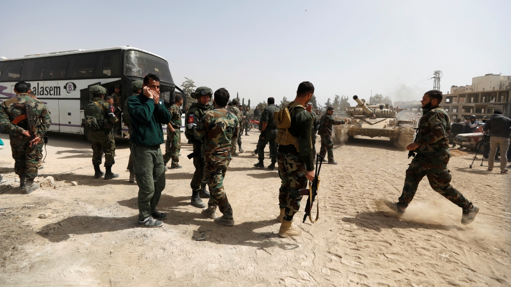 Syrian army soldiers are seen at the entrance of Harasta