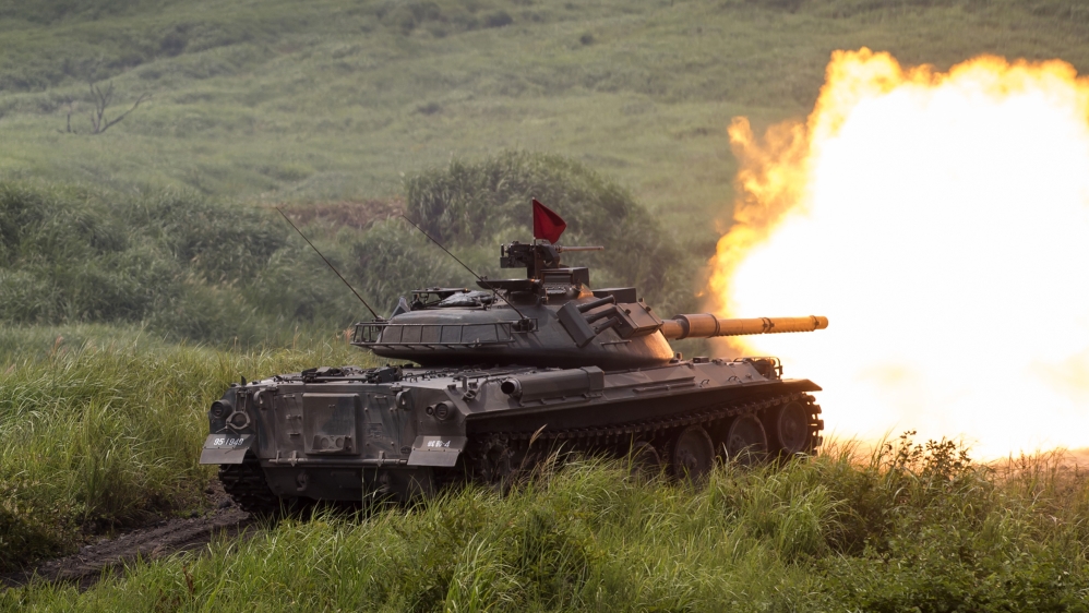 A Japan Ground Self-Defense Force (JGSDF) Type 74 battle tank fires ammunition during a live-fire exercise on August 24, 2017 [Tomohiro Ohsumi/Getty Images via Reuters]
