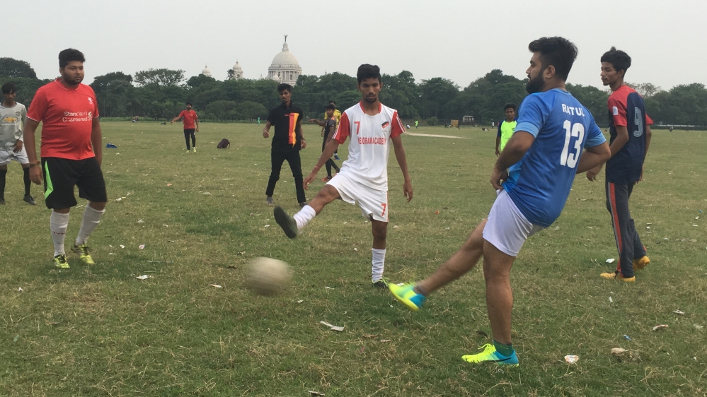 East Bengal supporters enjoy a kickabout in one of Kolkata's parks [Adnan Bhat/Al Jazeera]