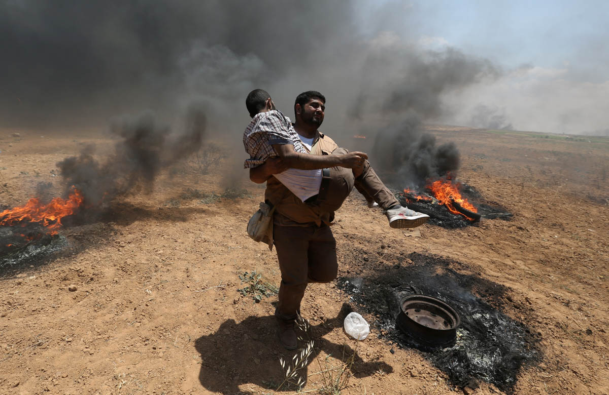 A wounded Palestinian demonstrator is evacuated during a protest against U.S. embassy move to Jerusalem and ahead of the 70th anniversary of Nakba, at the Israel-Gaza border in the southern Gaza Strip