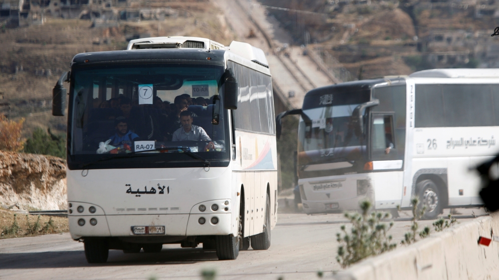 Buses carrying rebels who were evacuated with their families from al-Rastan are seen in Homs countryside