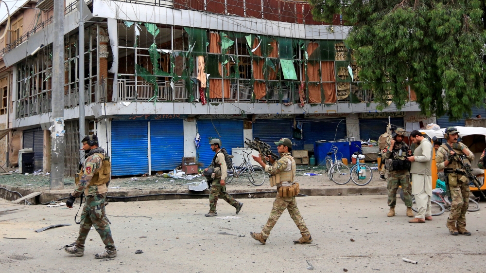 Afghan security forces keep watch during blasts and gunbattle at the site in Jalalabad city