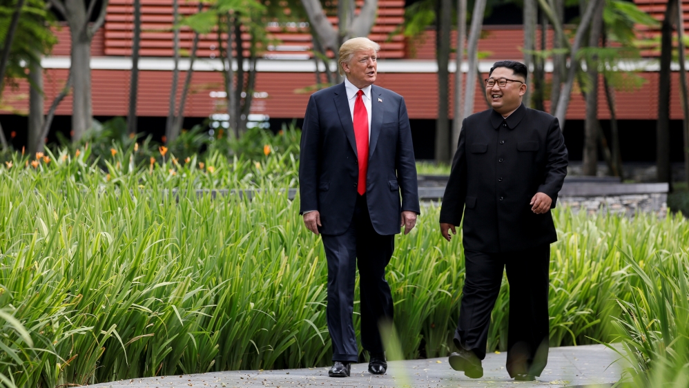 U.S. President Trump and North Korea''s Kim walk together before their working lunch during their summit in Singapore