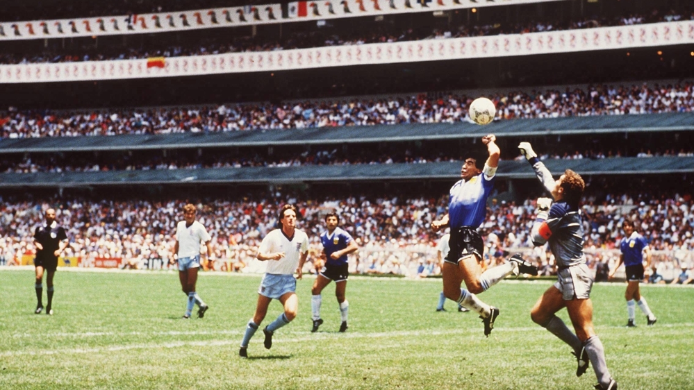 The iconic photo of the 'hand of God', when Maradona scored against England in 1986 [Bongarts/Getty Images]
