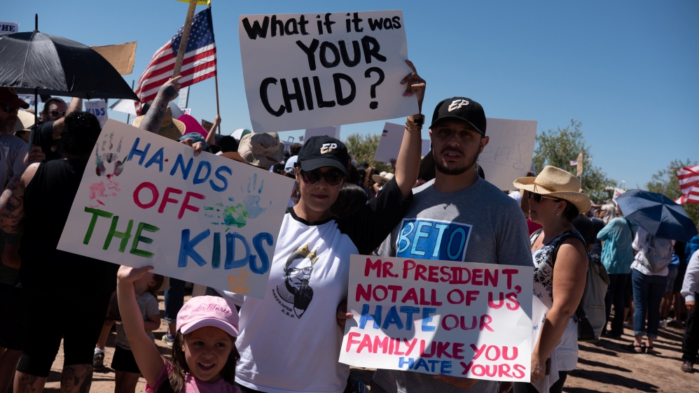 People participate in a protest against recent US immigration policy in Texas on Sunday [Monica Lozano/Reuters]