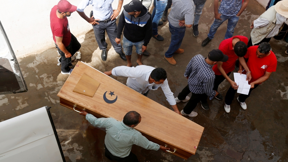Relatives carry a coffin containing the body of an immigrant who drowned when a boat sank, at a hospital morgue in Sfax