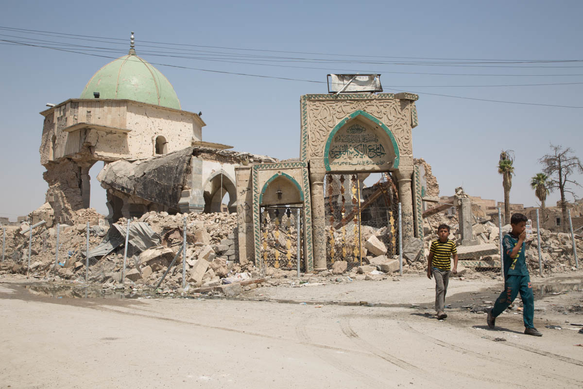 Picture 5 Children walk by the remains of the Great Mosque of al-Nuri in Mosul, Iraq. Built in 1172–1173,the mosque was destroyed by the Islamic State group on 21 June 2017. This historical mosque was