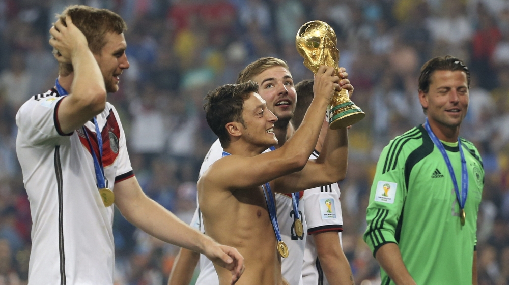  Ozil holds the World Cup trophy after Germany beat Argentina at the 2014 final in Brazil [Antonio Lacerda/EPA] Ozil holds the World Cup trophy after Germany beat Argentina at the 2014 final in Brazil [Antonio Lacerda/EPA]

