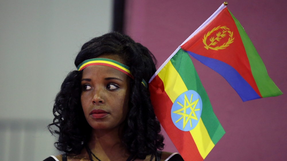 Woman wears the Ethiopian and Eritrean national flags during a concert in Addis Ababa