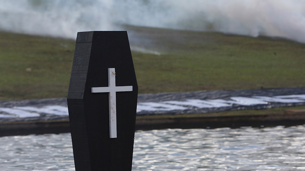 A fake coffin representing an indigenous person killed in the conflict over the demarcation of indigenous lands stands outside the National Congress [File: Eraldo Peres/AP Photo] 