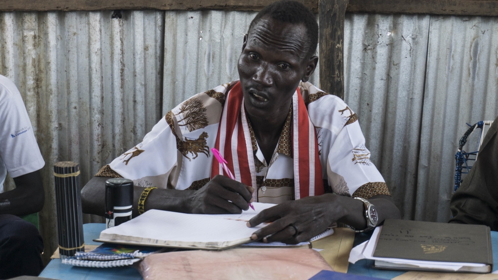 William Ruach, head magistrate, warns court attendants as he presides over a feud between two families [Tendai Marima/Al Jazeera]