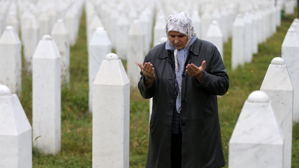 Hatidza Mehmedovic prays near the graves of her two sons and husband in Memorial Center in Potocari near Srebrenica