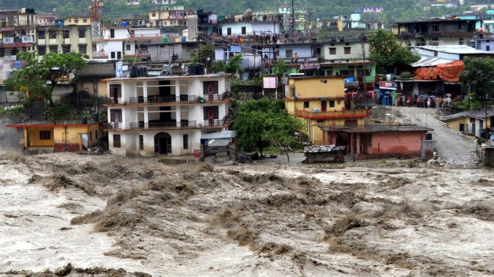 Houses are partly submerged in the flooded River Ganges in Uttarakashi district, in the northern Indian state of Uttarakhand, India, June 18, 2013 [AP]