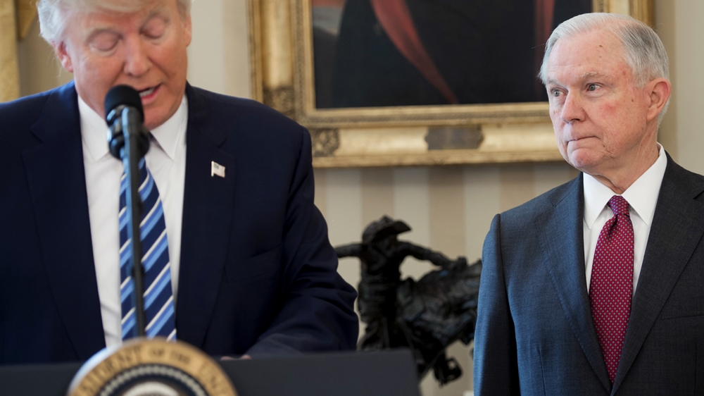 Trump alongside Jeff Sessions after Sessions was sworn in as Attorney General [Saul Loeb/AFP]