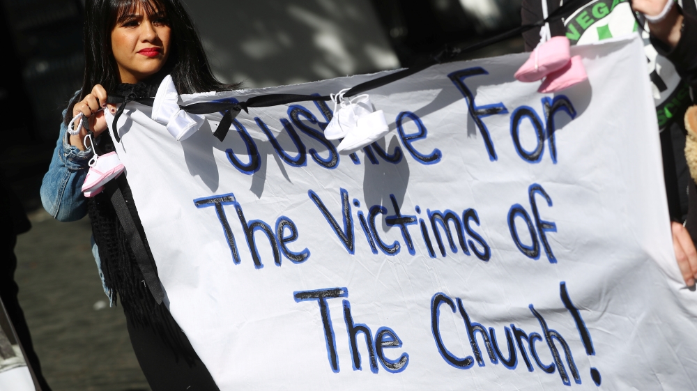 Protesters hold banners during a demonstration against clerical sex abuse, in Dublin