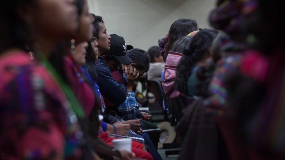 A man holds his head in his hands as the court reads their decision to acquit former intelligence chief Jose Mauricio Rodriguez [Jeff Abbott/Al Jazeera] 