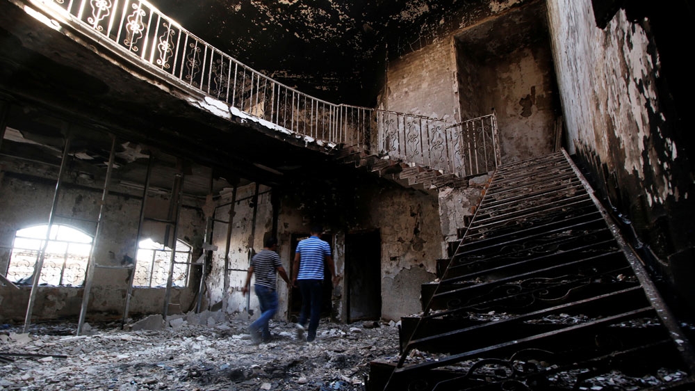 The headquarters of Asaib Ahl al-Haq (pictured) was among the buildings set on fire by protesters [Essam al-Sudani/Reuters]