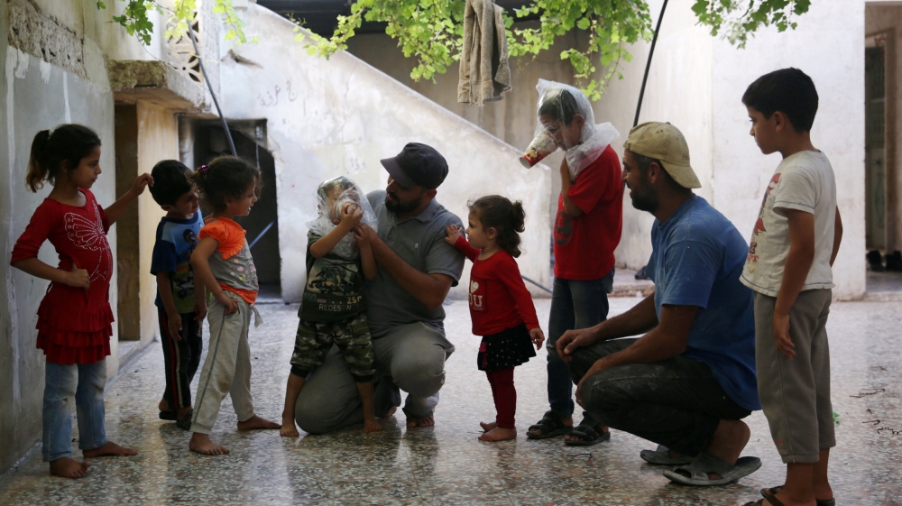 A boy tries an improvised gas mask in Idlib