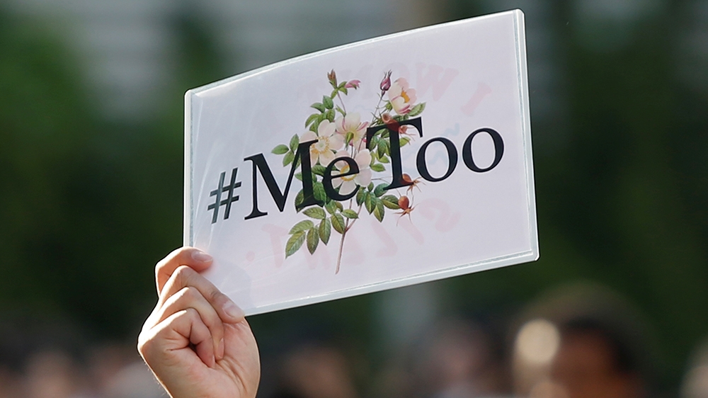 A protester raises a placard reading "#MeToo" during a rally against harassment at Shinjuku shopping and amusement district in Tokyo, Japan, April 28, 2018. Picture taken April 28, 2018. REUTERS/Issei