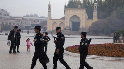 Uighur security personnel patrol near the Id Kah Mosque in Kashgar in western China''s Xinjiang region.
